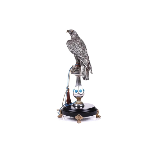 422 - Lorenzo Sandomar, a large model of a silver and gold plated falcon, marked 925, standing on a facete... 