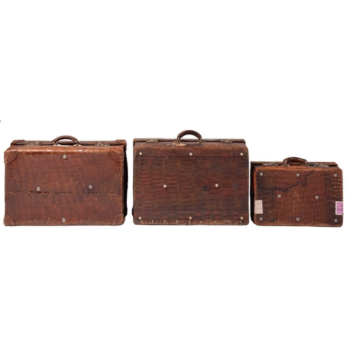 434 - A near pair of crocodile skin type leather suitcases, early 20th century, one with fitted interior, ... 