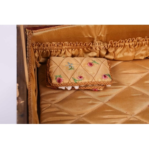 435 - A regency sewing box of casket form, green morocco decorated with brass appliques, on four lion paw ... 