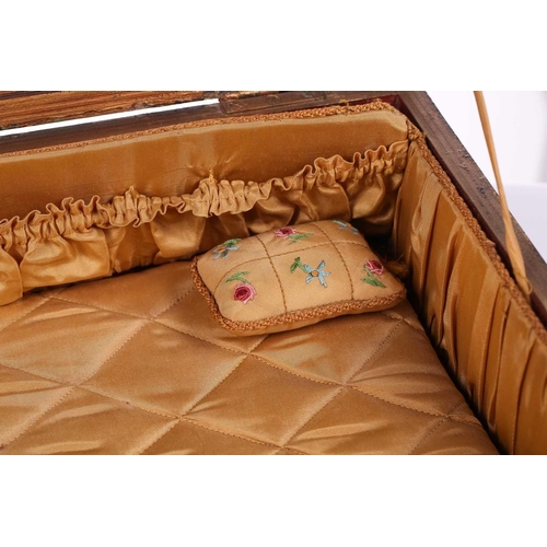 435 - A regency sewing box of casket form, green morocco decorated with brass appliques, on four lion paw ... 