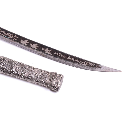 454 - A Thai white metal-mounted short sword with niello worked curving blade the hilt and scabbard of ova... 