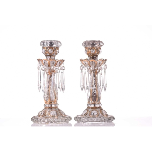 467 - A pair of Victorian glass storm lights, with white enamel floral decoration and gilt highlights, the... 