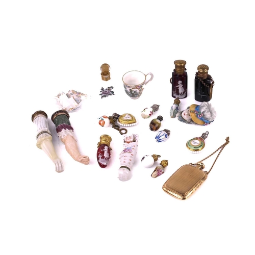 472 - A collection of miniature porcelain and glass scent bottles and containers, to include two modelled ... 