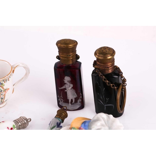 472 - A collection of miniature porcelain and glass scent bottles and containers, to include two modelled ... 