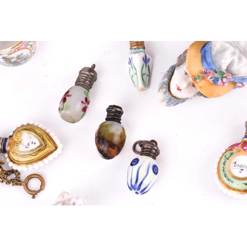 472 - A collection of miniature porcelain and glass scent bottles and containers, to include two modelled ... 