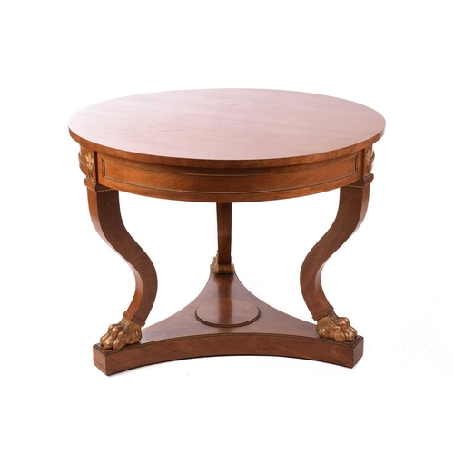 130 - A French Empire Style centre table, the circular top over a gilt beaded panelled frieze and flaming ... 