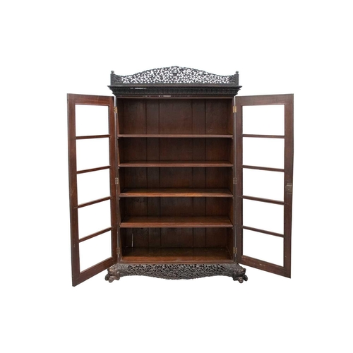 133 - A 19th-century well-carved Anglo Indian rosewood/padauk wood two-door bookcase, c.1850s, with pierce... 