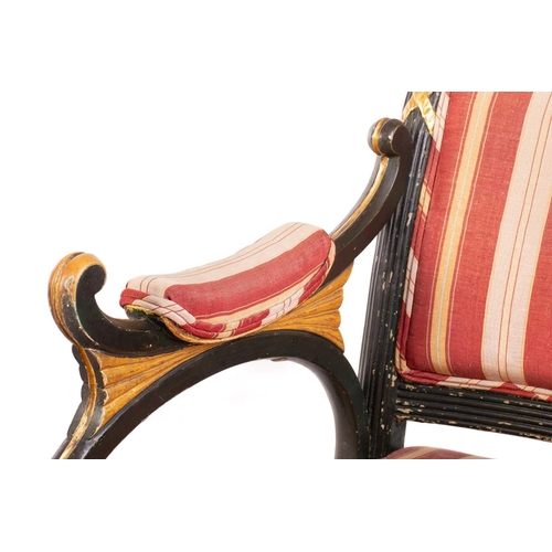 145 - A pair of Regency and later painted and parcel gilt library armchairs with floral carved cresting ra... 