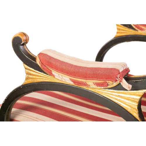 145 - A pair of Regency and later painted and parcel gilt library armchairs with floral carved cresting ra... 