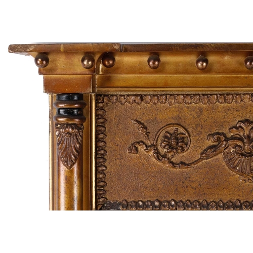 150 - A Regency carved wood and gilt gesso pier glass, the inverted breakfront frame with sphere set corni... 