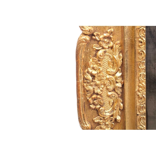 151 - A 19th-century moulded and gilt plaster mirror with bevelled glass, the crest with a bird amongst ro... 