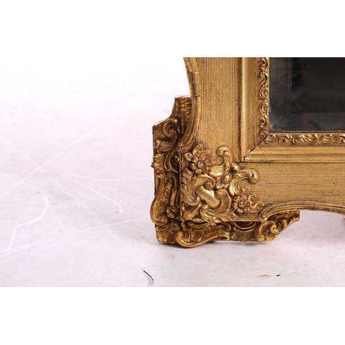 151 - A 19th-century moulded and gilt plaster mirror with bevelled glass, the crest with a bird amongst ro... 