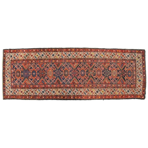 152 - An antique Hammadan runner with a central star lozenge pole on a blue ground within multiple borders... 