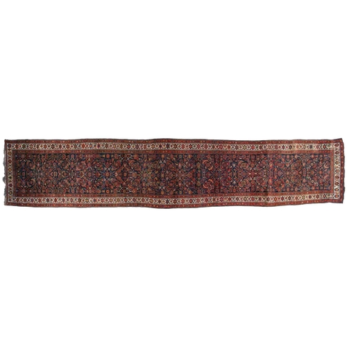 153 - A long antique Bidjar runner with Herat motif on a dark blue ground within multiple borders, 5.5 mtr... 