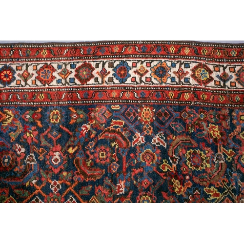 153 - A long antique Bidjar runner with Herat motif on a dark blue ground within multiple borders, 5.5 mtr... 