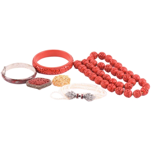 122 - A collection of costume jewellery, including a red laquer floral brooch measuring 48 x 34mm, an imit... 