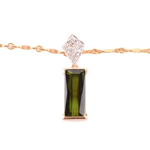 124 - A tourmaline and diamond ring and similar pendant on chain; the ring features an elongated baguette-... 