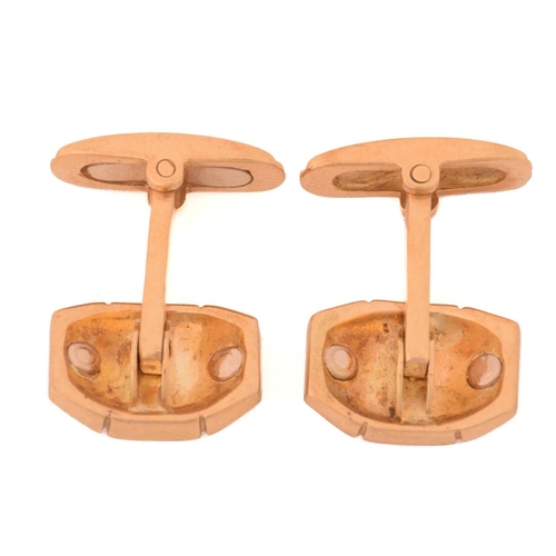 129 - A pair of sapphire and diamond cufflinks, each consisting of an octagonal plaque, centred with a sap... 