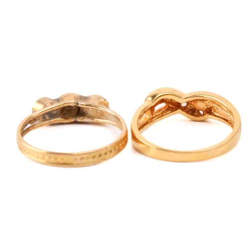 131 - Six yellow metal rings; to include a diamond-set crossover ring, size M; a three-stone turquoise hal... 