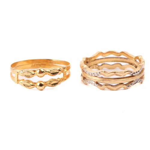 131 - Six yellow metal rings; to include a diamond-set crossover ring, size M; a three-stone turquoise hal... 