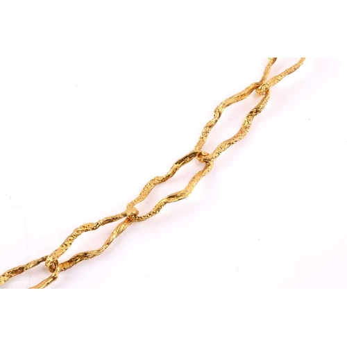133 - A textured peanut link chain, organically textured, connected by a gilt spring-ring clasp, yellow me... 