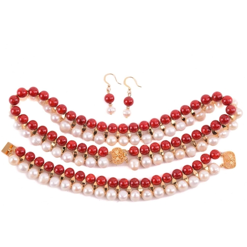 134 - A cultured pearl and dyed red howlite suite of jewellery, comprising necklace, bracelet and earrings... 