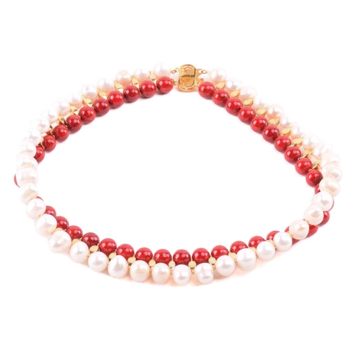 134 - A cultured pearl and dyed red howlite suite of jewellery, comprising necklace, bracelet and earrings... 