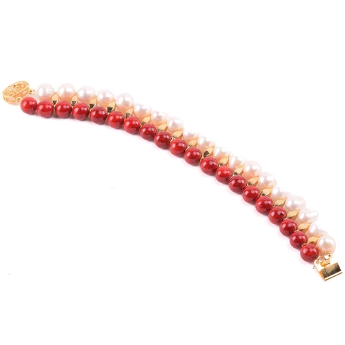 134 - A cultured pearl and dyed red howlite suite of jewellery, comprising necklace, bracelet and earrings... 