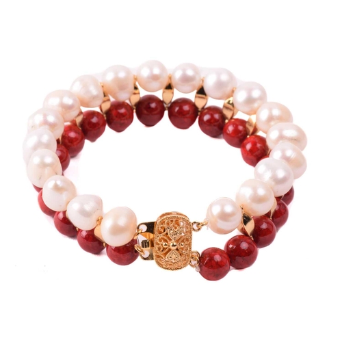134 - A cultured pearl and dyed red howlite suite of jewellery, comprising necklace, bracelet and earrings... 