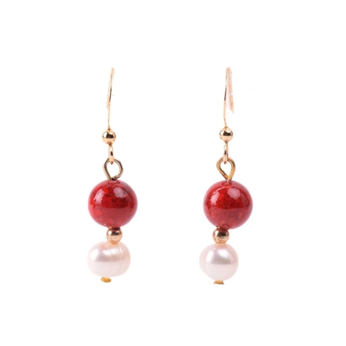 134 - A cultured pearl and dyed red howlite suite of jewellery, comprising necklace, bracelet and earrings... 