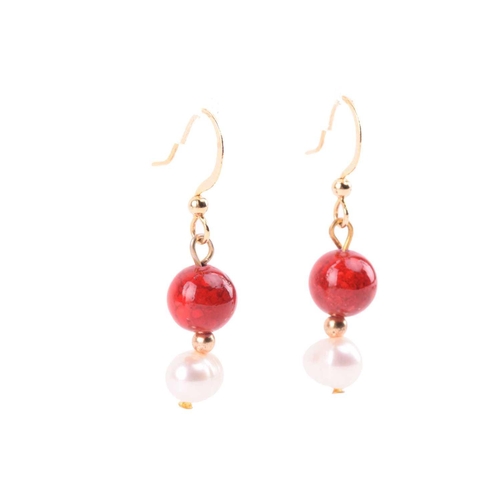 134 - A cultured pearl and dyed red howlite suite of jewellery, comprising necklace, bracelet and earrings... 