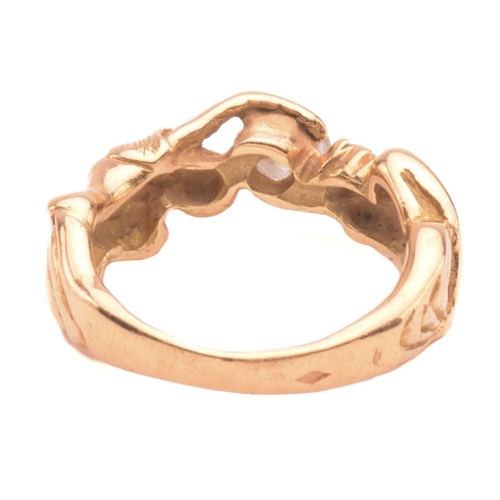 138 - A French figural ring set with diamond, stylised as a man and woman hugging a brilliant-cut diamond,... 