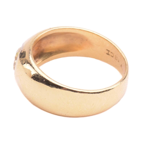 139 - A diamond gypsy ring, flush-set with a round brilliant-cut diamond of light yellow colour, with an e... 