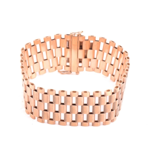14 - A five-row panther link bracelet in 9ct yellow gold, completed with a concealed tongue clasp and dou... 