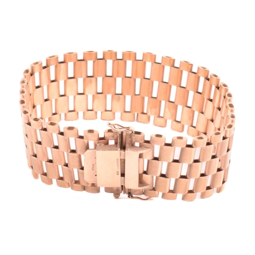 14 - A five-row panther link bracelet in 9ct yellow gold, completed with a concealed tongue clasp and dou... 