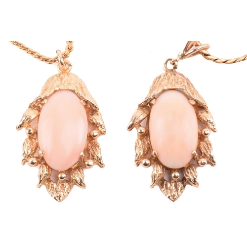 143 - Two coral-set pendants on chain together with matching clip-on earrings; the identical pendants of f... 