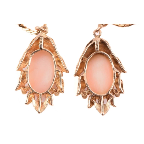 143 - Two coral-set pendants on chain together with matching clip-on earrings; the identical pendants of f... 