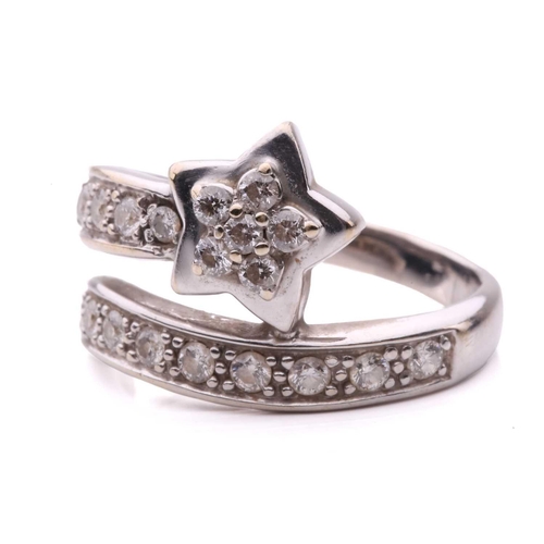 144 - A diamond set star ring, designed as a shooting star set with round brilliant cut diamonds with a to... 