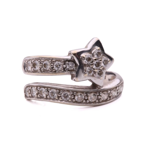 144 - A diamond set star ring, designed as a shooting star set with round brilliant cut diamonds with a to... 