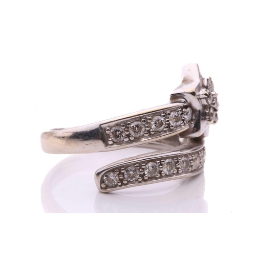 144 - A diamond set star ring, designed as a shooting star set with round brilliant cut diamonds with a to... 