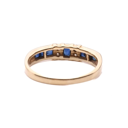 15 - A sapphire and diamond half-hoop ring, segments channel-set with square table-cut sapphires, flanked... 
