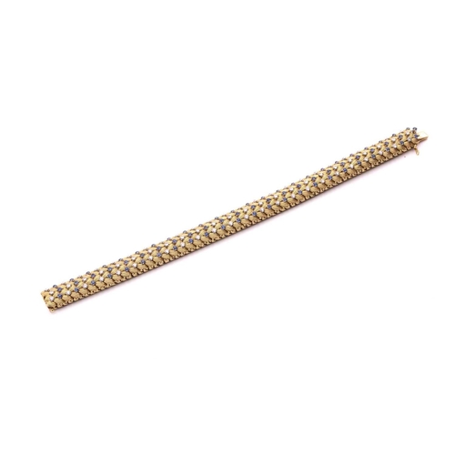 150 - Illario - a diamond and sapphire snake link bracelet, circa 1960, the articulated links of foliate d... 