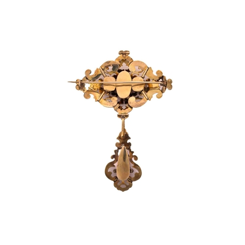 151 - An early to mid 19th-century topaz brooch; the central lozenge -shaped panel of open scrolling desig... 