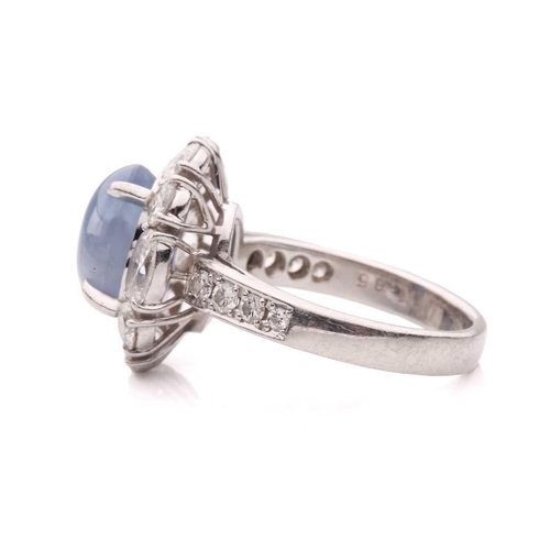 158 - A star sapphire and diamond entourage ring, centred with a star sapphire of 9.7 x 7.7 x 6.0 mm, with... 