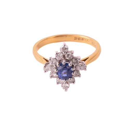 162 - A sapphire and diamond cluster ring, the central sapphire measuring 5.4mm x 4.5mm x 3.6mm, surrounde... 