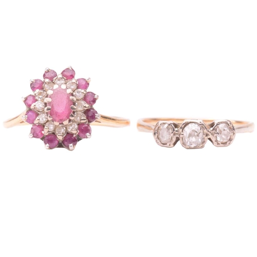164 - A three stone diamond ring together with a ruby and diamond cluster ring; the first set with a trio ... 