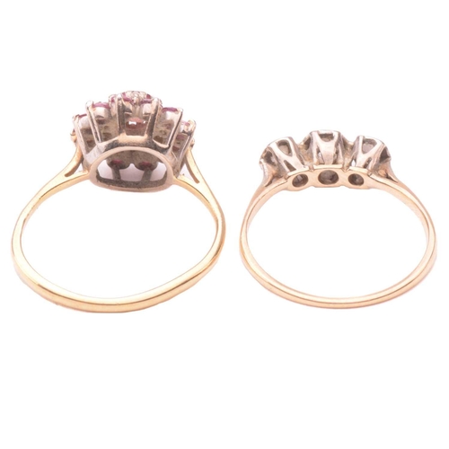 164 - A three stone diamond ring together with a ruby and diamond cluster ring; the first set with a trio ... 