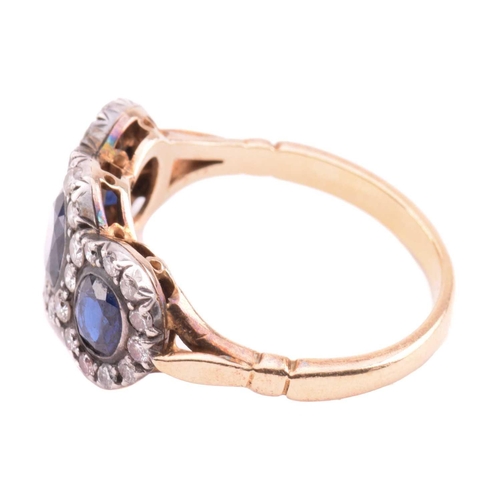 166 - A sapphire and diamond triple cluster ring, the central cushion shape sapphire measuring 5.7mm x 5mm... 