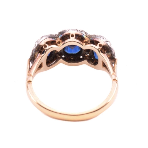 166 - A sapphire and diamond triple cluster ring, the central cushion shape sapphire measuring 5.7mm x 5mm... 