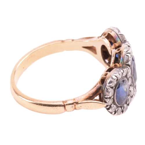 166 - A sapphire and diamond triple cluster ring, the central cushion shape sapphire measuring 5.7mm x 5mm... 